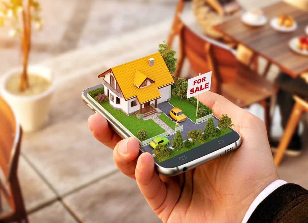 Imagem ilustra uma casa virtual em relevo, à venda, na tela de um smartphone