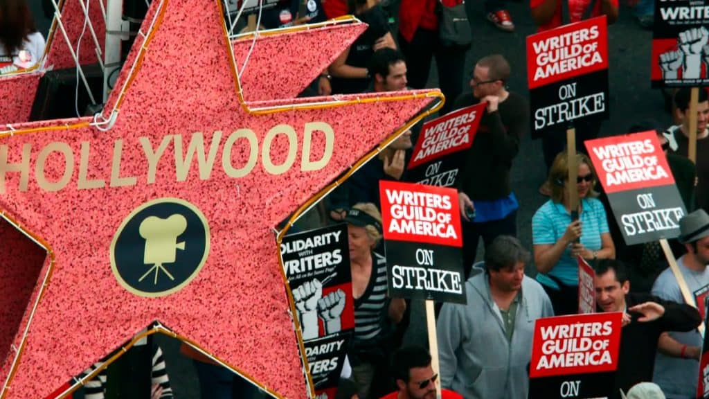 Estrela com Hollywood escrito e roteiristas com placas de protesto ao fundo